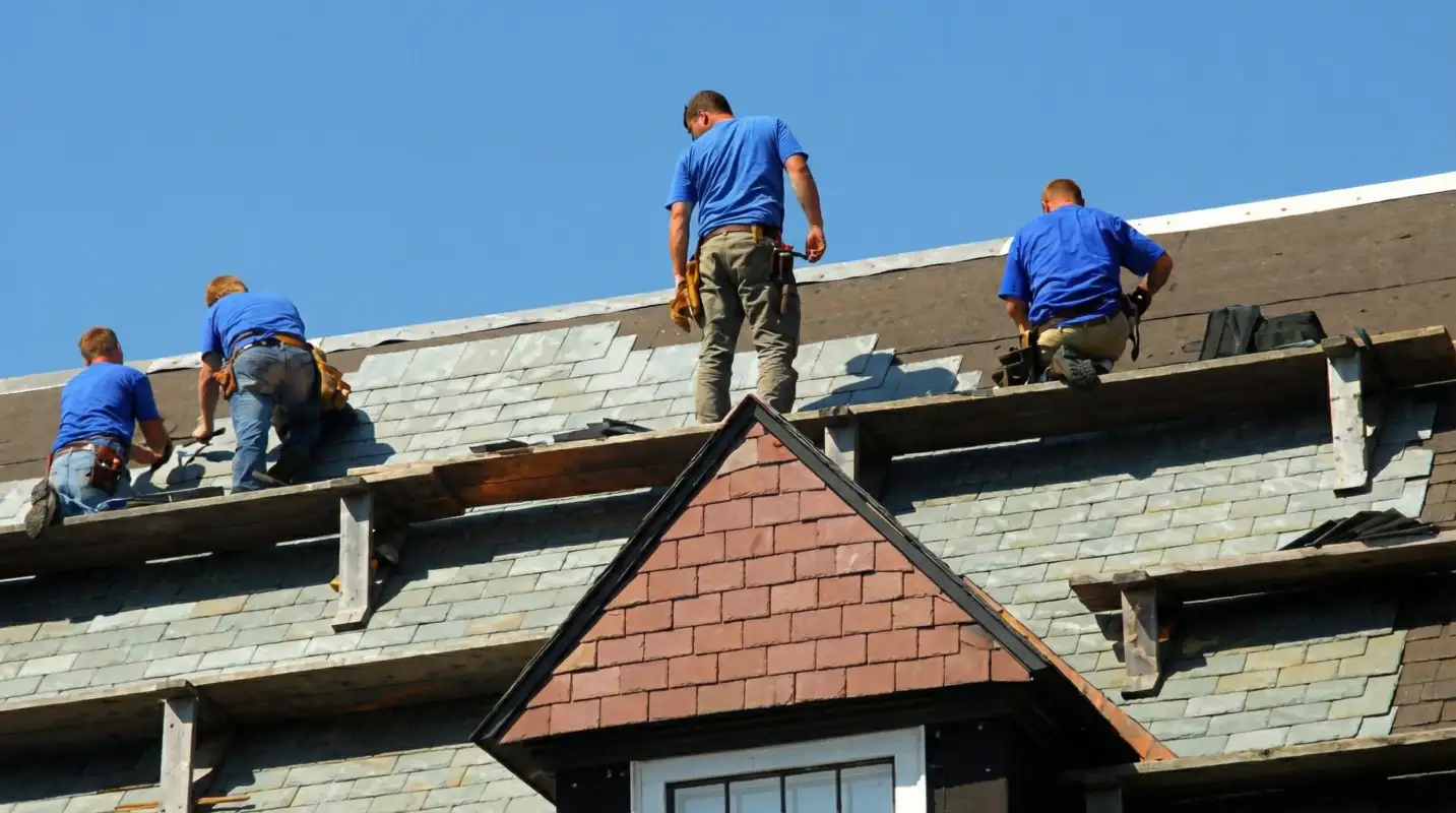 Roof replacement in progress with a team of professional contractors installing new shingles on a residential home in Columbus, GA