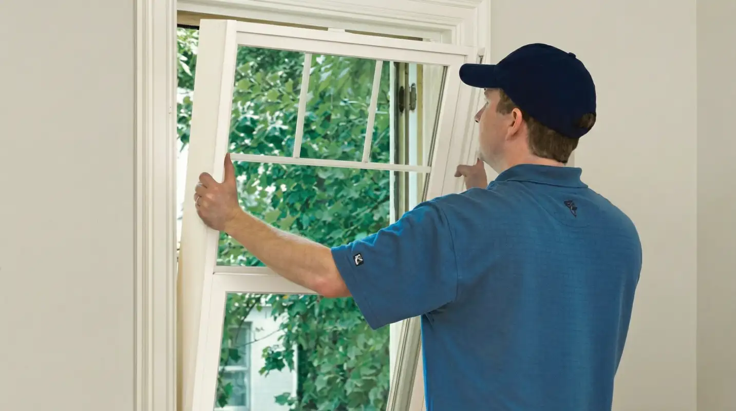 Professional contractors performing a residential window insulation and replacement service in Columbus, GA